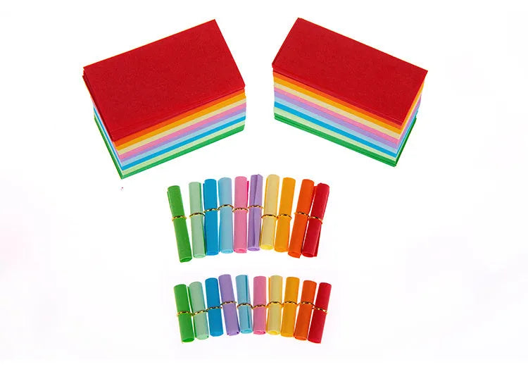 Assorted coloured miniature paper scrolls for drift bottle messages, showing pre-punched hole.