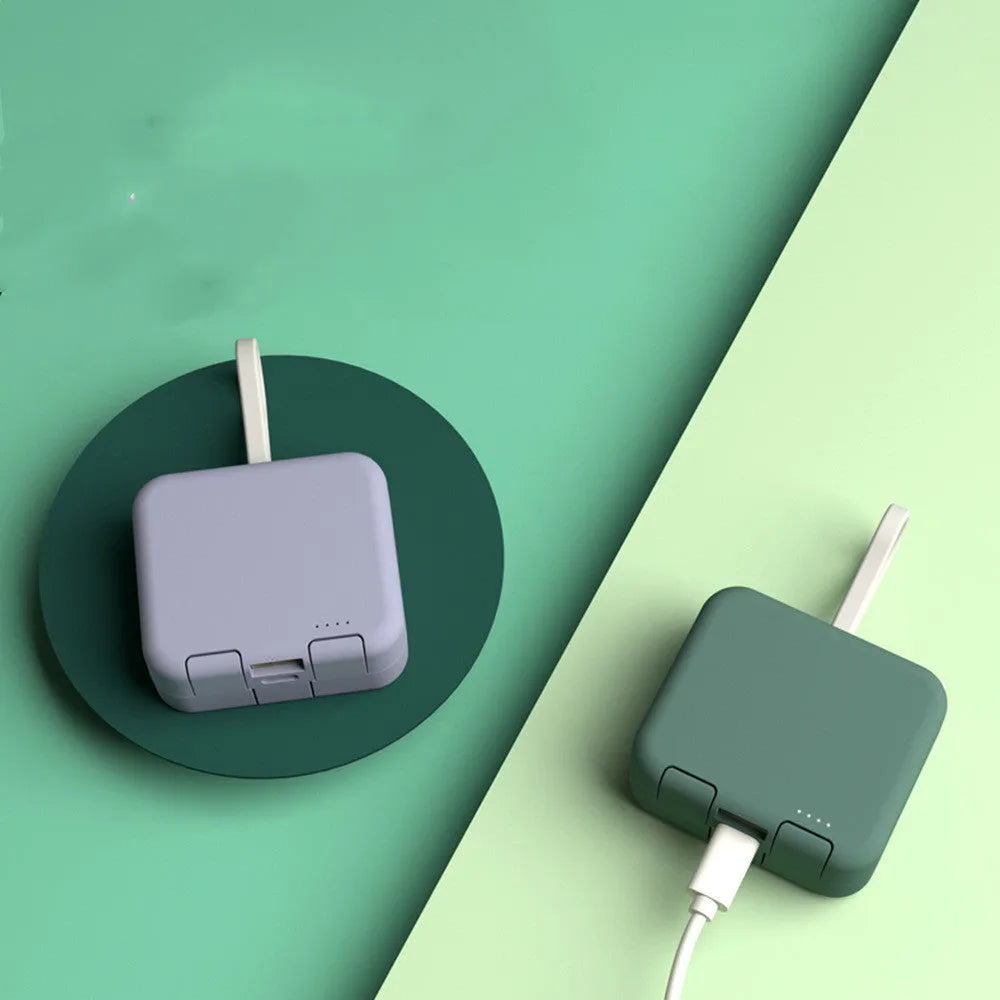 Handbag back clip power bank in blue, showing clip detail and phone standing in its holder mode.