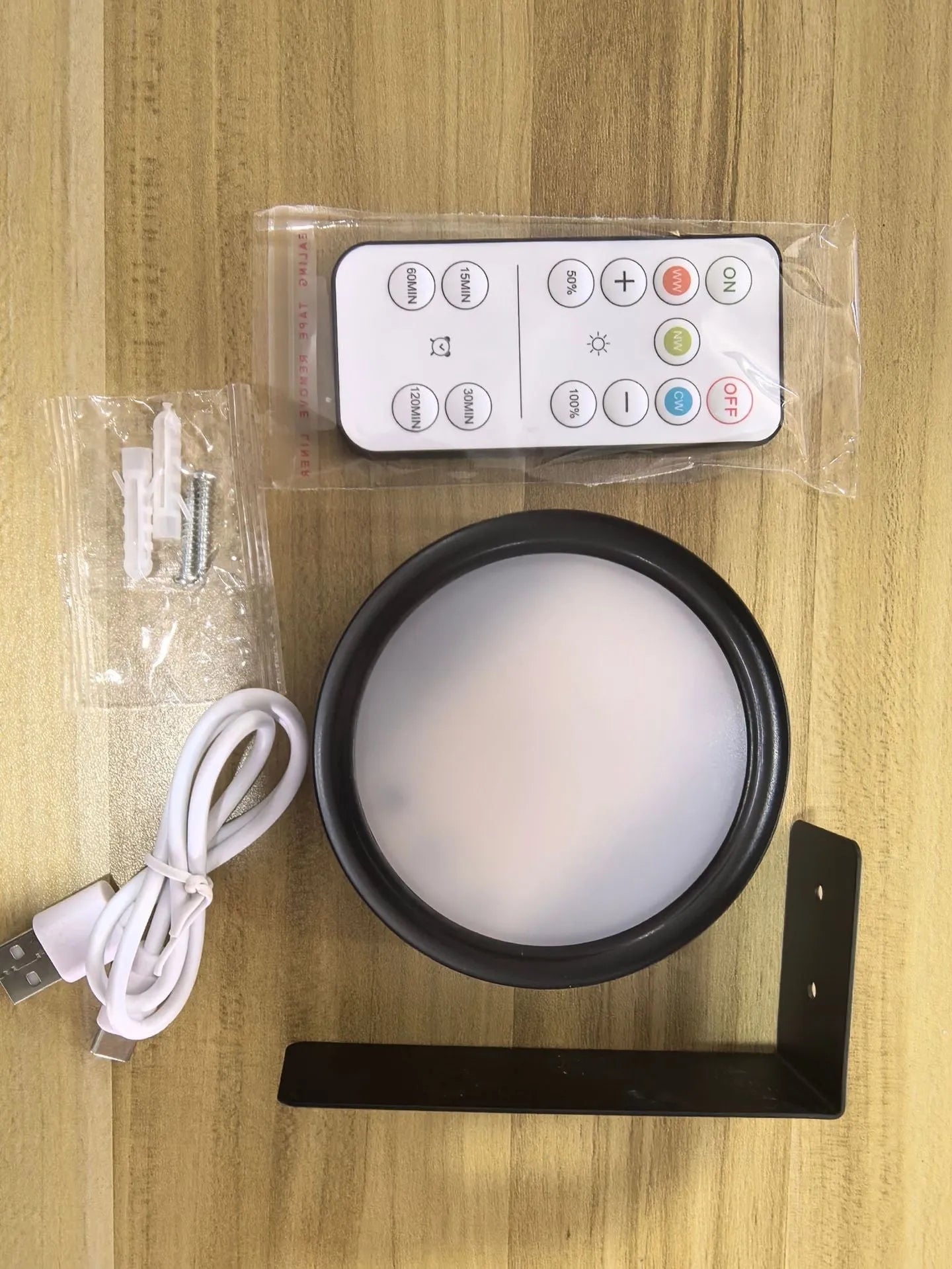 Wireless rechargeable LED painting lamp with magnetic belt attached to a metal frame, remote control nearby.
