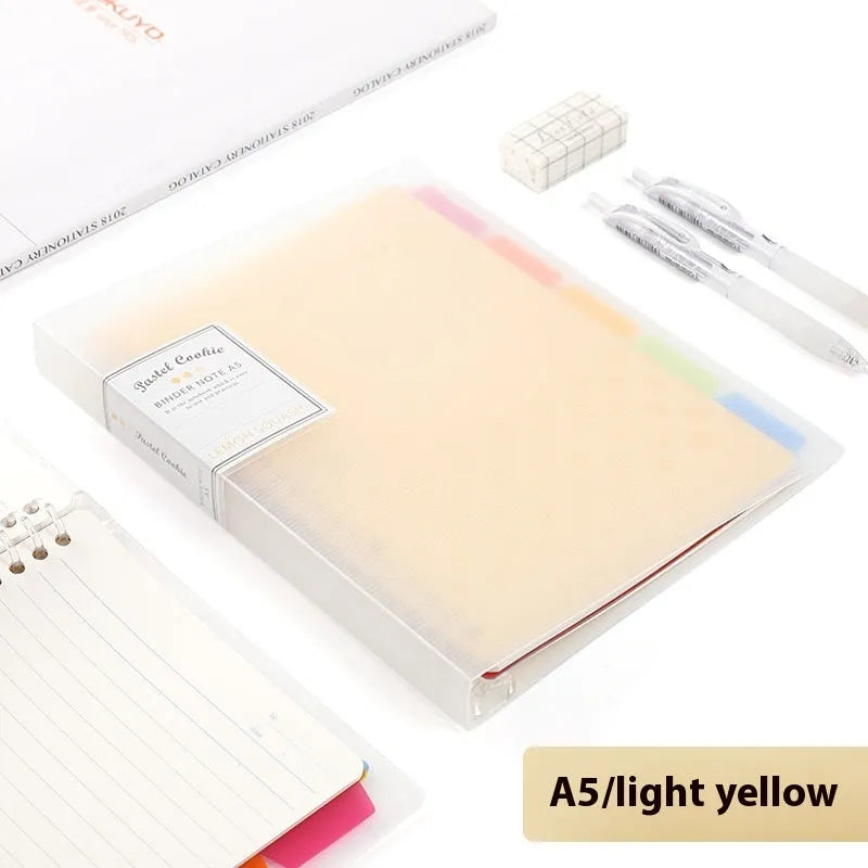 Loose-leaf spiral notebook with PP cover open, showing raw wood pulp pages in A5 or B5 size.