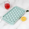 Large blue silicone ice cube tray with 33 round grids and a clear lid
