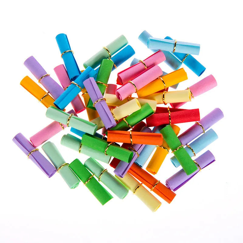 Assorted coloured miniature paper scrolls for drift bottle messages, showing pre-punched hole.