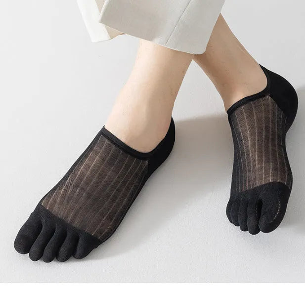 Modal five-finger boat socks in black, shown on a foot with invisible no-show style.