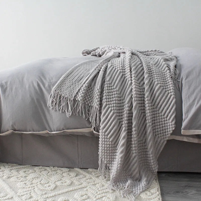 Small light grey polyester nap blanket folded, showing its 127x170cm size.