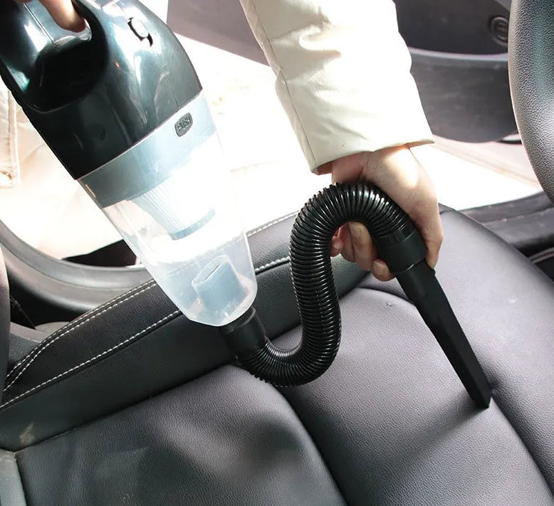 Orange, black, and blue coloured 12V handheld car vacuum cleaner with nozzle attachments on a 5m cord.