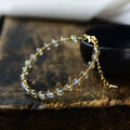 Women's blue moonstone bracelet with 6mm crystal and 14K gold-plated gilded metal band.