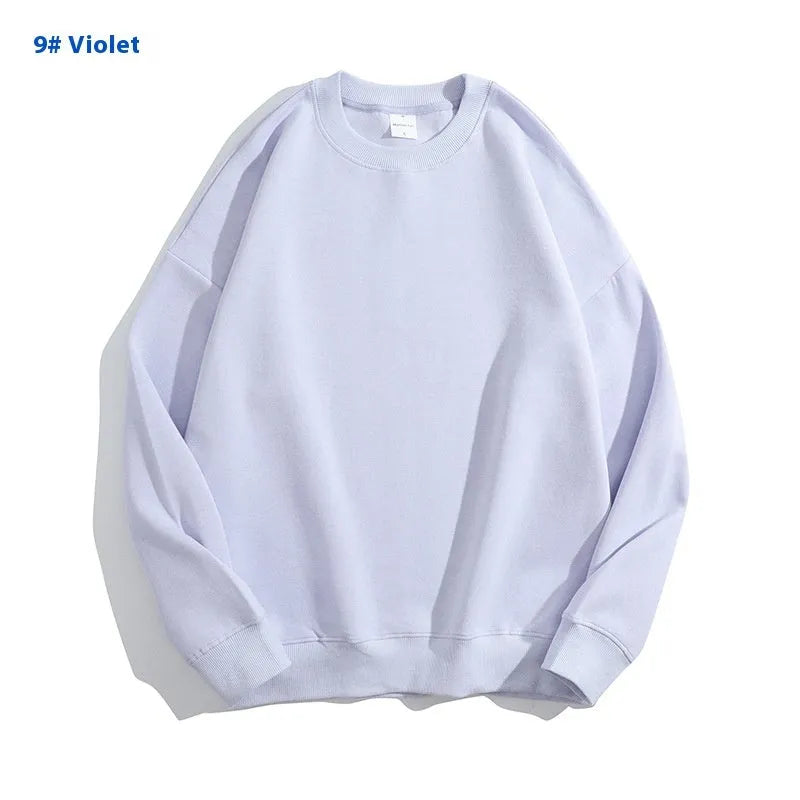 A loose-fitting, off-shoulder cotton sweater in a solid colour with long sleeves and a round neck.