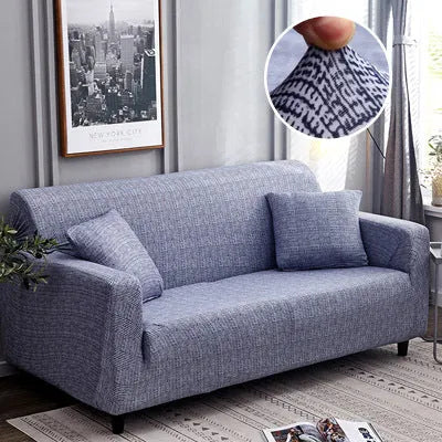 Geometric patterned stretch sofa slipcover fitted on a modern two-seater sofa.