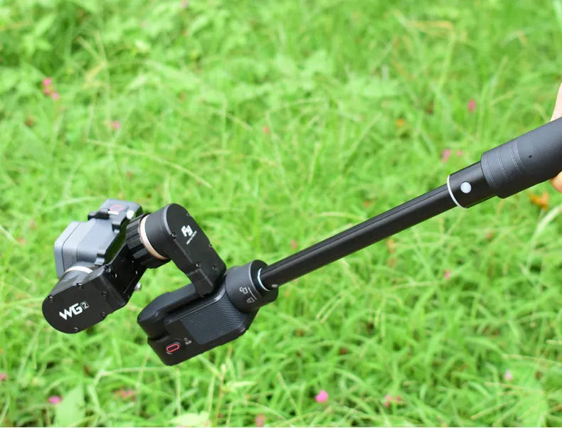 Black aluminium retractable selfie stick with stabilizer, shown extended and with built-in tripod stand.