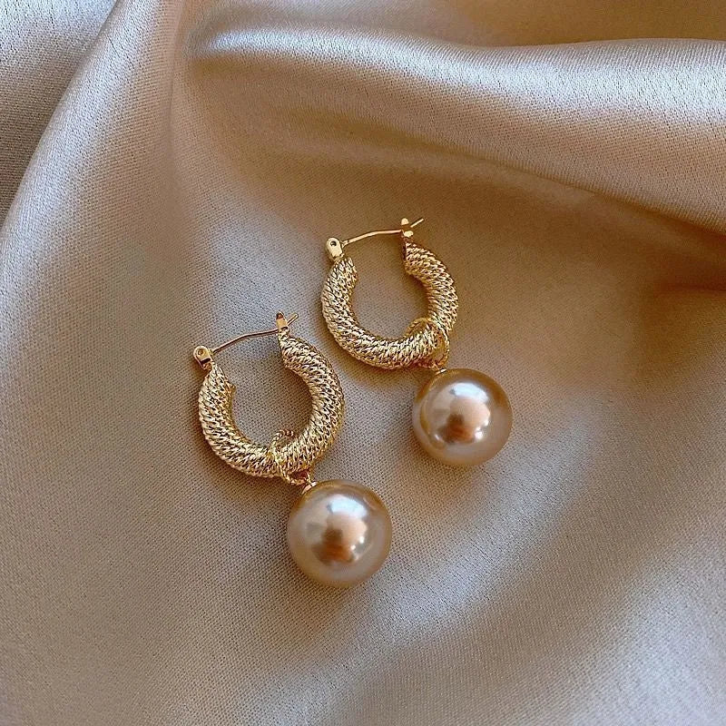 Women's geometric copper earrings with zircon and rose design elements in various colours