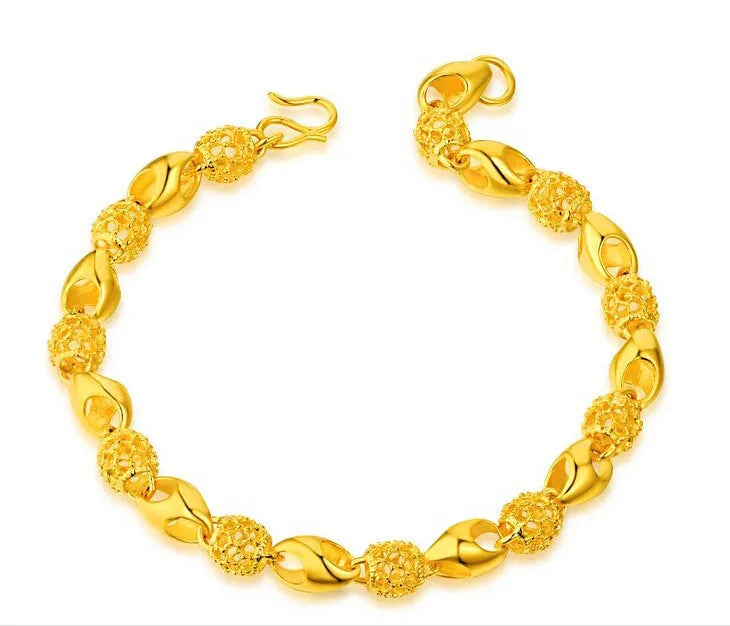 Gold-plated brass bracelet with thick vacuum gold coating on a white background