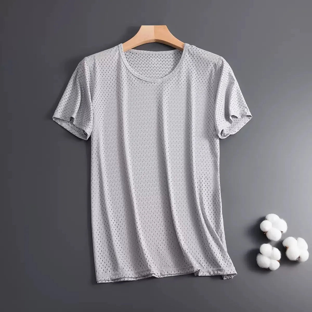 Man wearing a loose-fit grey Ice Silk short sleeve crew neck T-shirt.