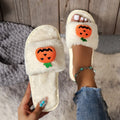 White and yellow Halloween cartoon pumpkin plush open-toe slippers with anti-slip PVC soles.