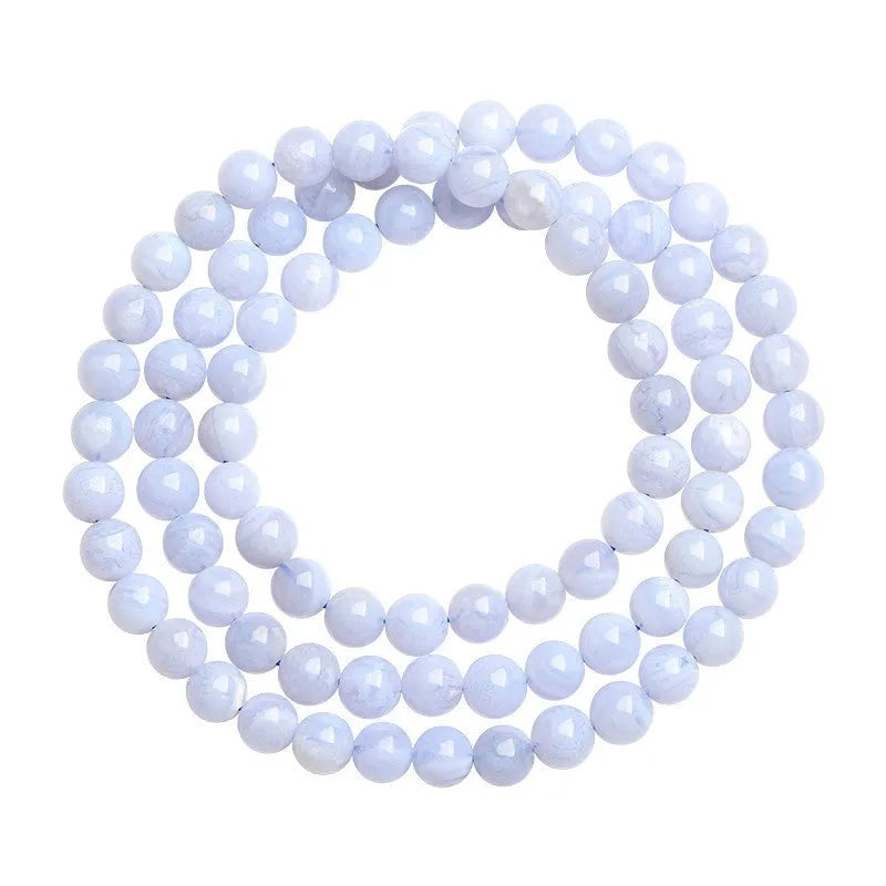 Blue agate bracelet with natural striped patterns, Ruyi design elements, and scattered bead arrangement