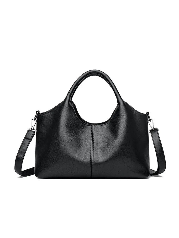 Women's genuine leather crossbody bag in beige colour showing soft construction and large capacity