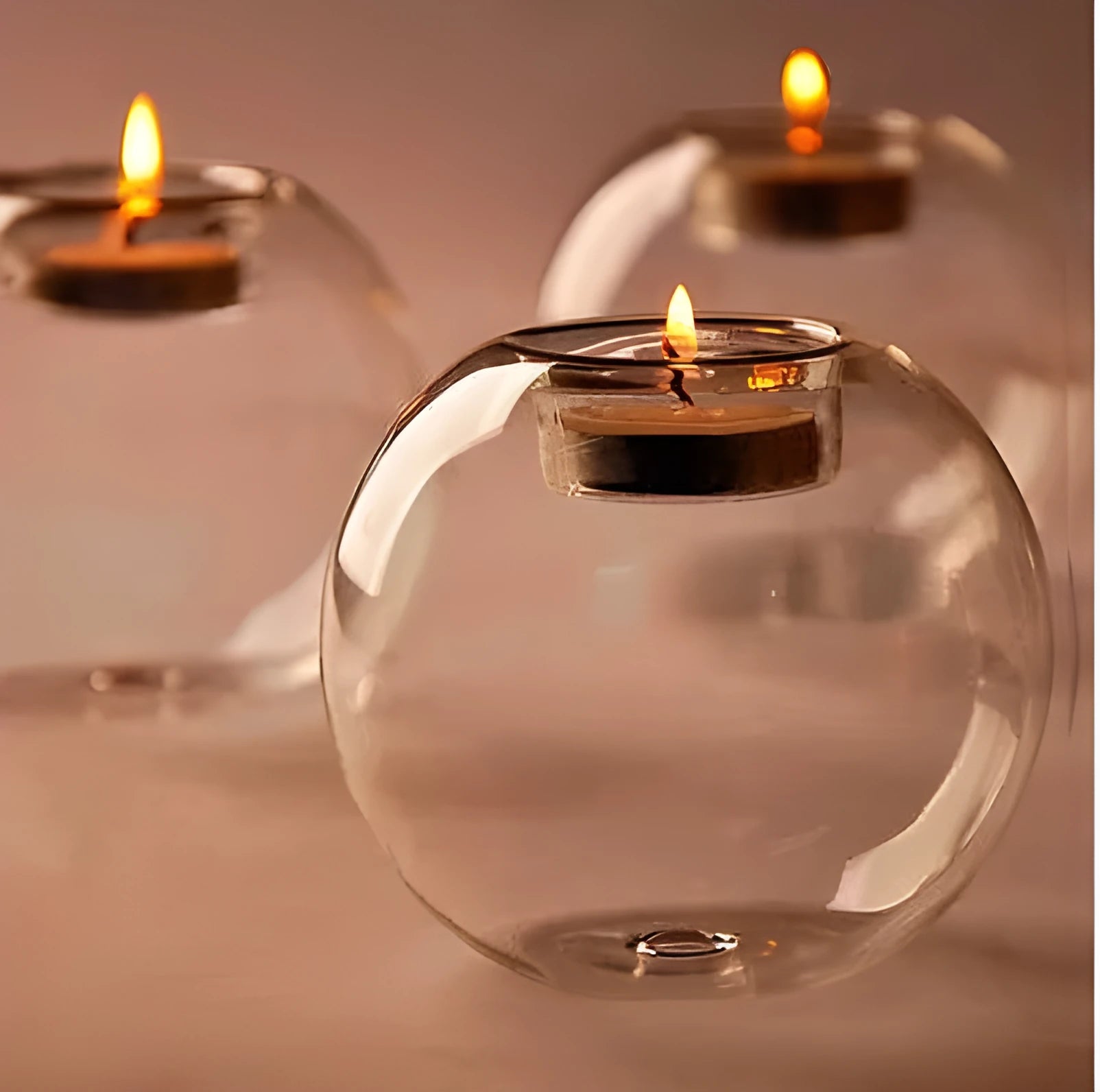Clear round hollow glass candle holder for a tea light on a table