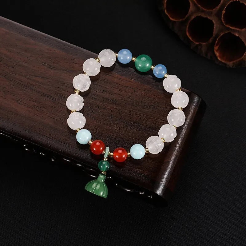 Carved pumpkin and lotus bead bracelet made from Bodhi root with white jade and aventurine details.