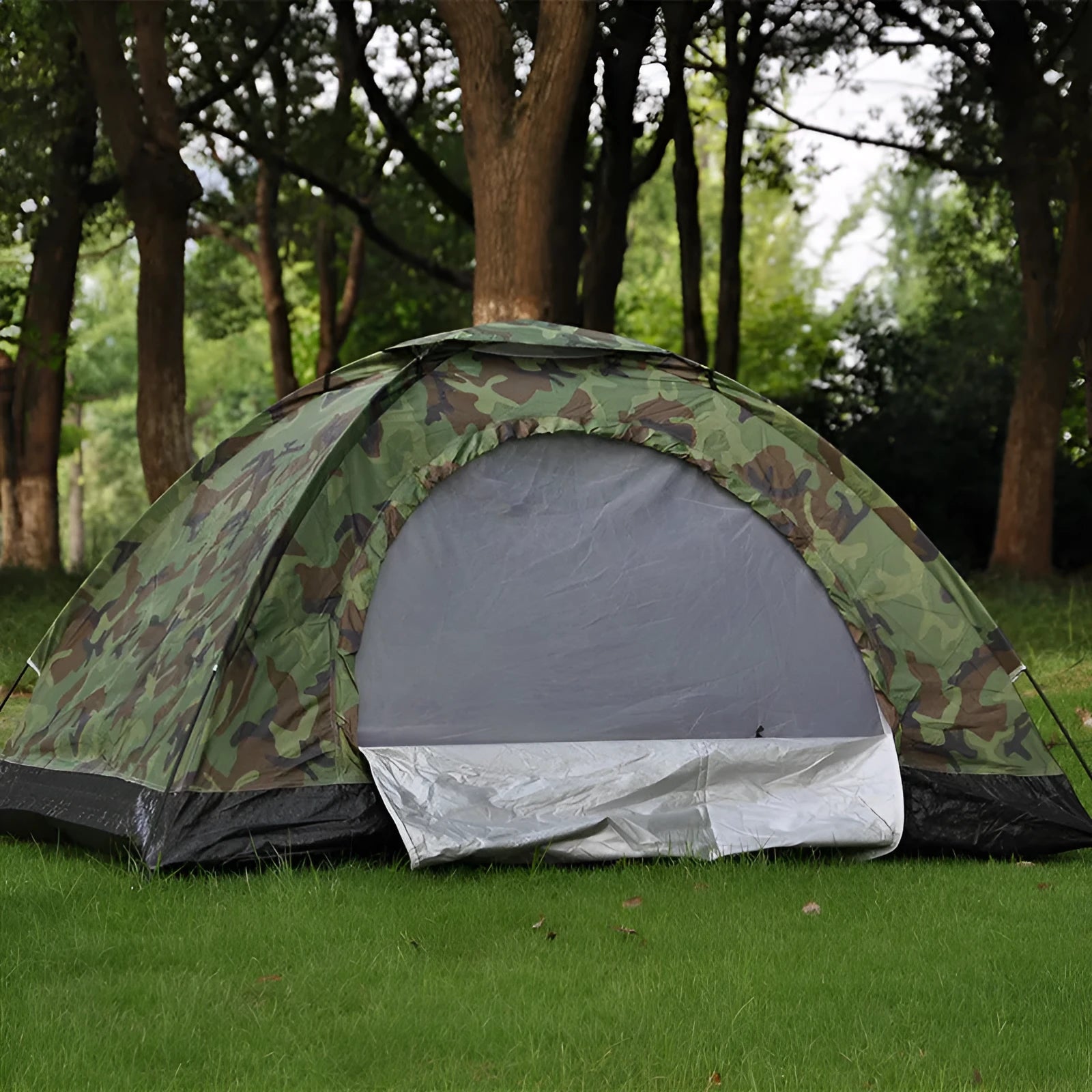 Green camouflage camping tent with mesh windows and steel ground pegs