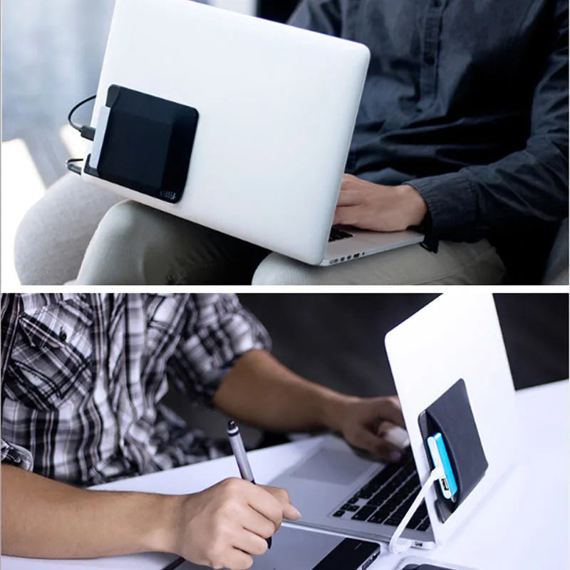 Black self-adhesive Lycra storage bag attached to back of laptop, 15x12cm, with pen loop and earphones visible