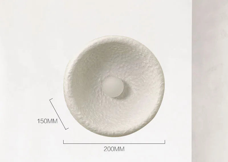 Japanese-style simple modern wall lamp with round resin shade in warm light