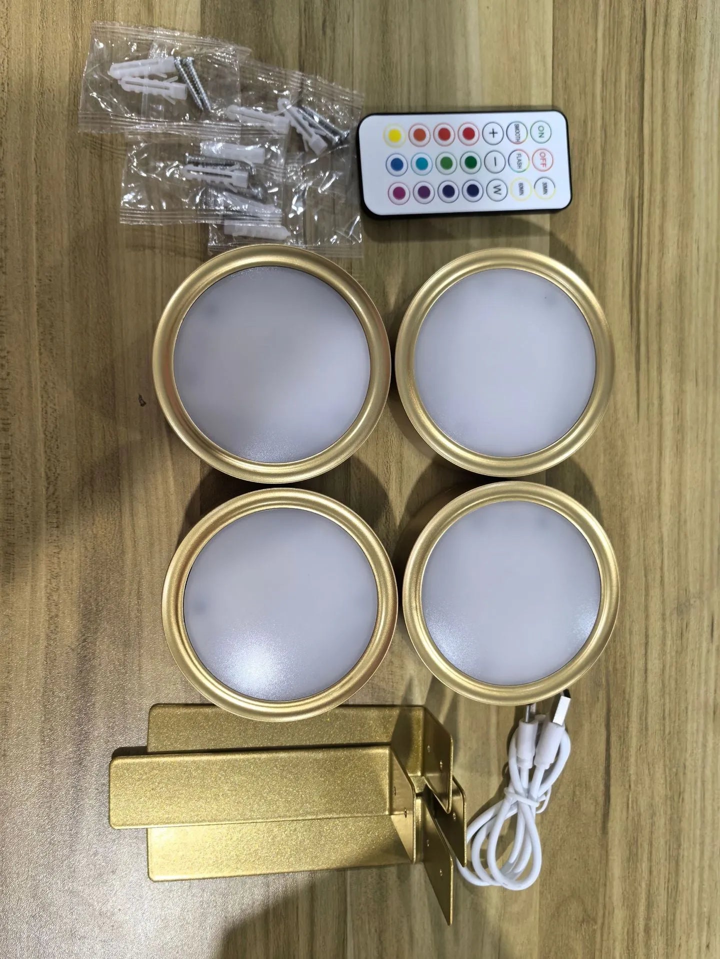 Wireless rechargeable LED painting lamp with magnetic belt attached to a metal frame, remote control nearby.