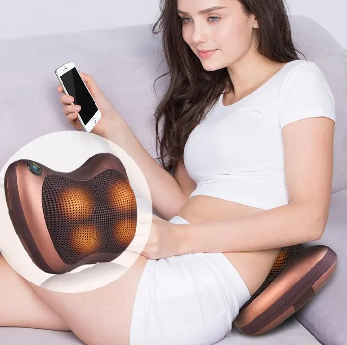 Electric infrared kneading massage pillow in black PU leather with control buttons and adjustable fixing strap for car seat use