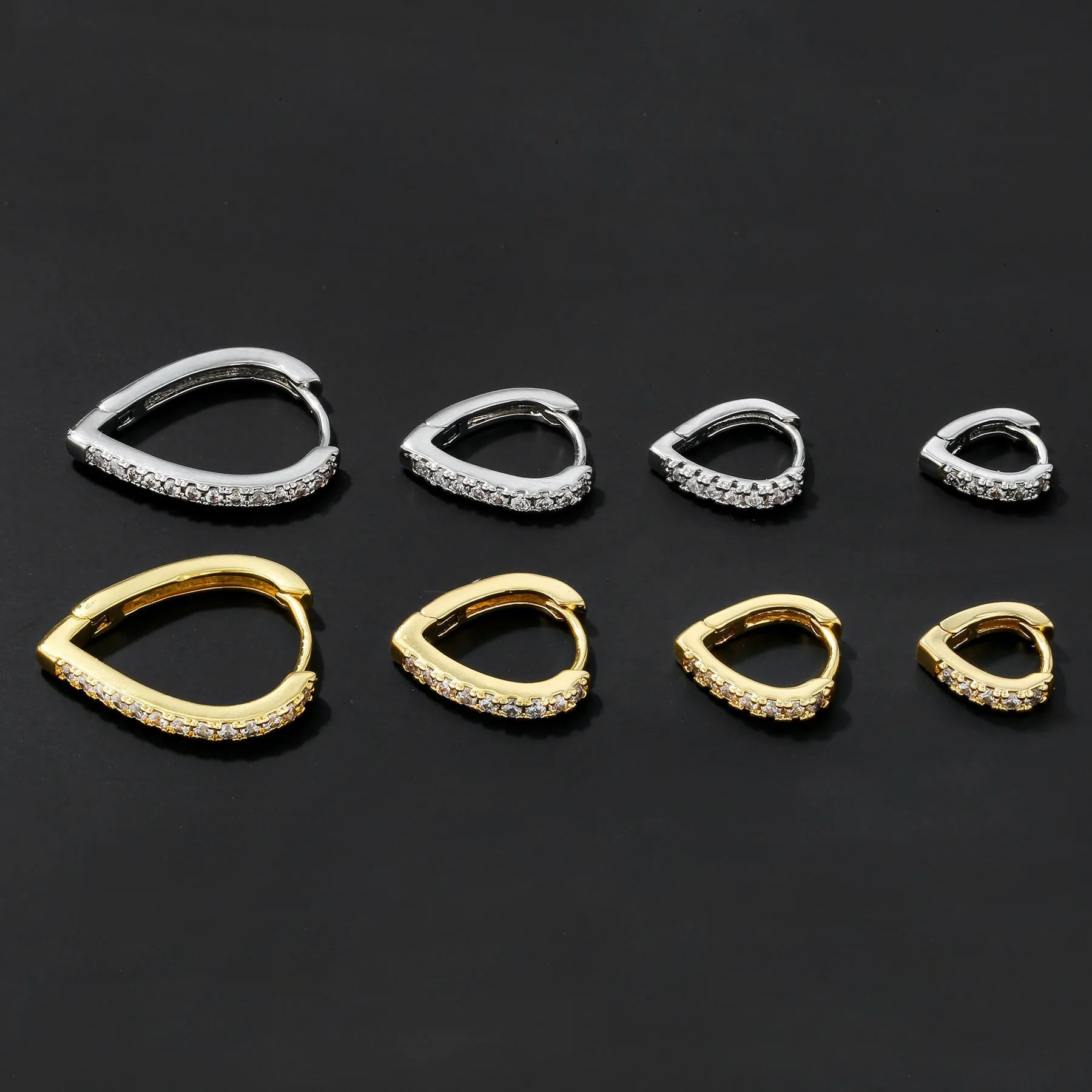 Gold geometric heart-shaped clip-on earring for women on a white background.