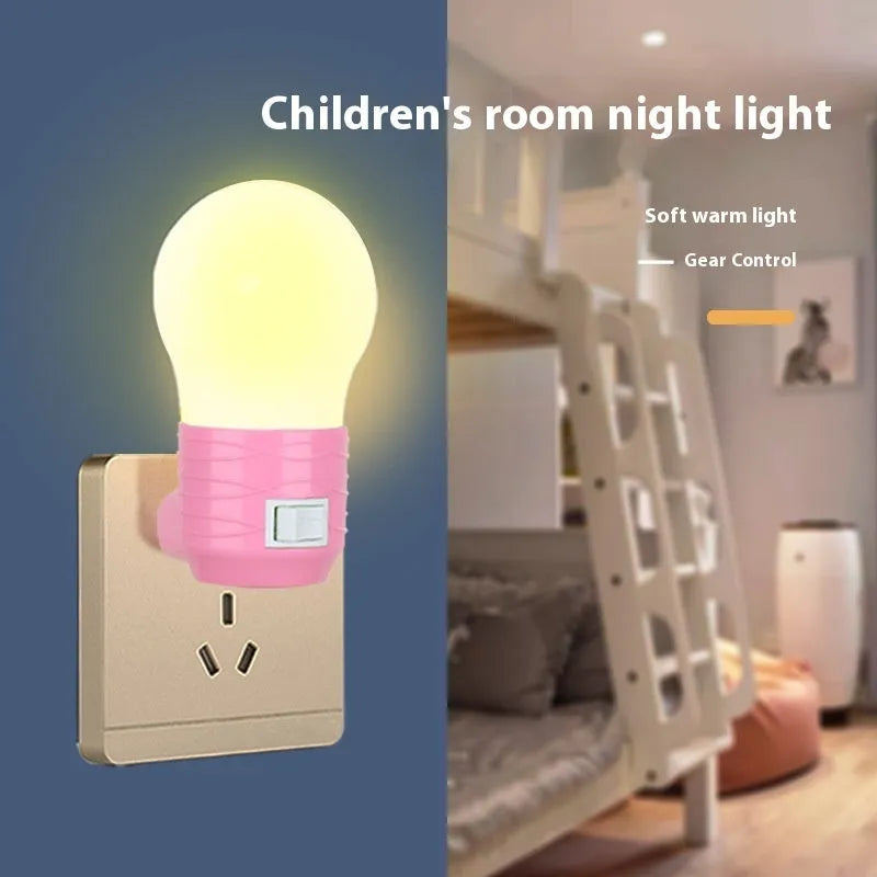 Plug-in bedside baby night light in white shell with modern round design on a table.