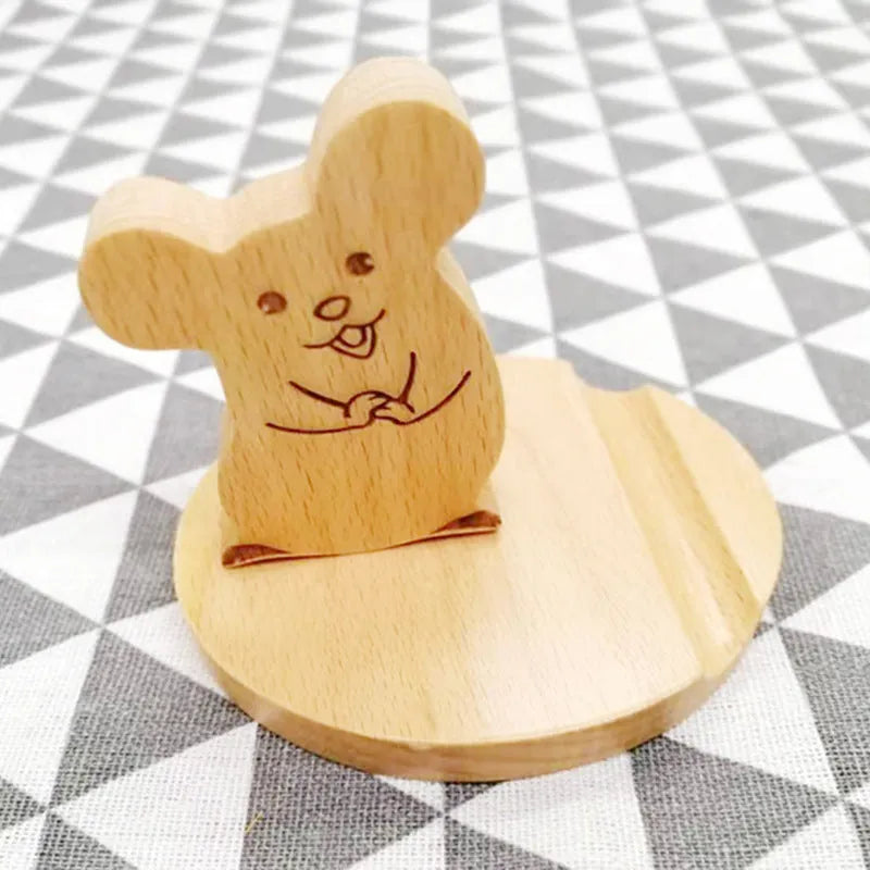 Beech wood mobile phone holder stand with coin slot and decorative carving.