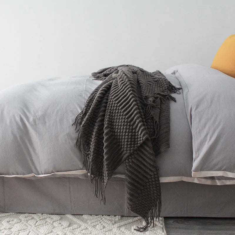 Small light grey polyester nap blanket folded, showing its 127x170cm size.
