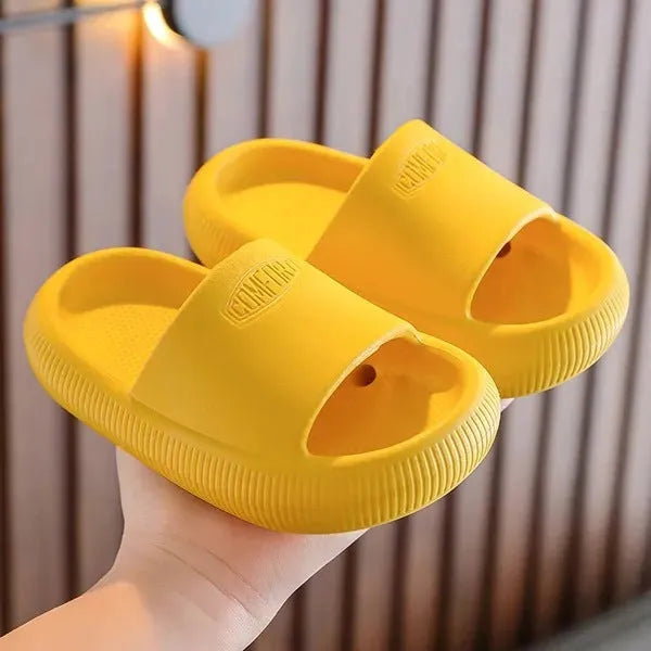 Mixed colour children's EVA slippers with non-slip soles in sizes for ages 24-35.