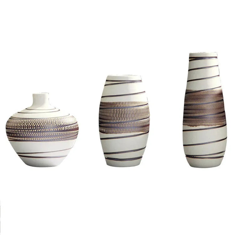 Three-piece ceramic vase set in low, medium, and tall sizes with vintage finish on a tabletop