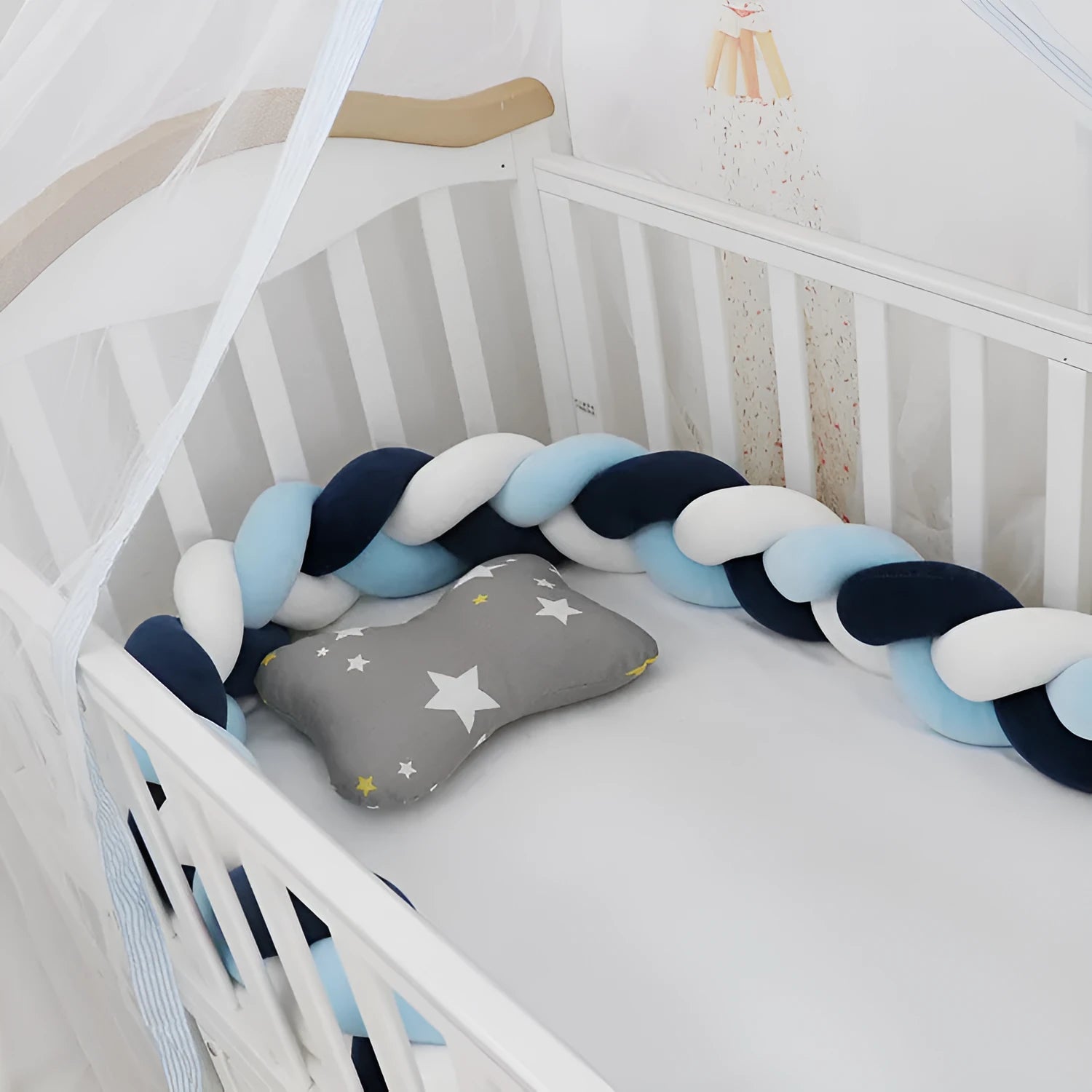 Braided knot baby crib bumper in spandex velvet wrapped around white cot rails.