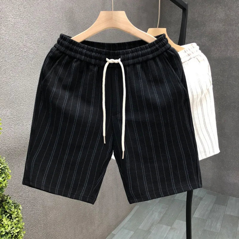 Men's black and white striped fleece-lined casual shorts with an ankle-banded cuff on a hanger.