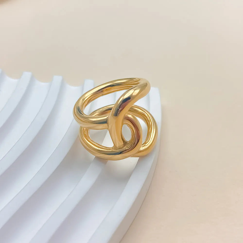 Women's adjustable stainless steel ring with knotted geometric design in gold or steel colour.