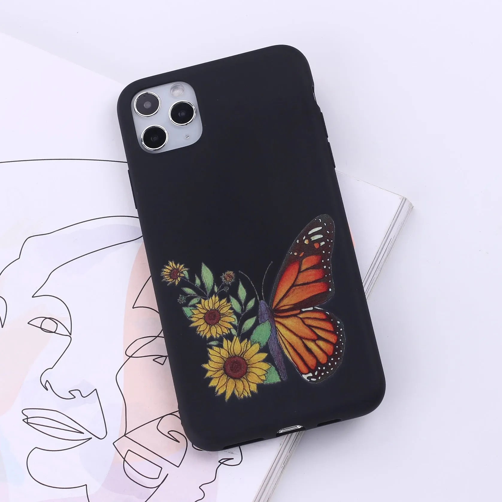 Slim TPU mobile phone case for iPhone on a table, showing one of 14 available colour options.