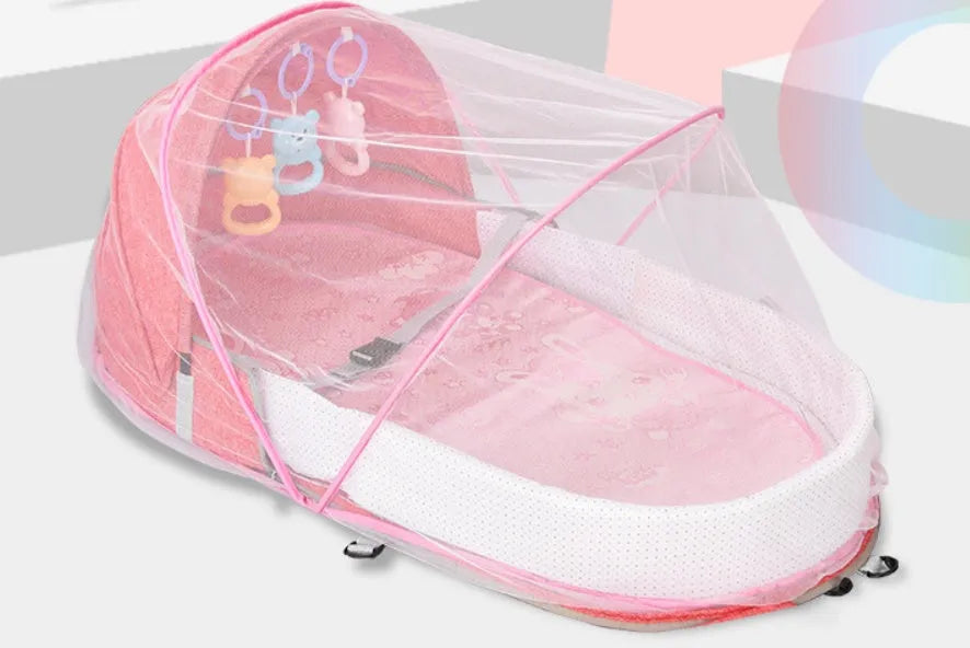 Portable foldable baby anti-mosquito isolation bed with grey cotton linen fabric, open on a grassy area