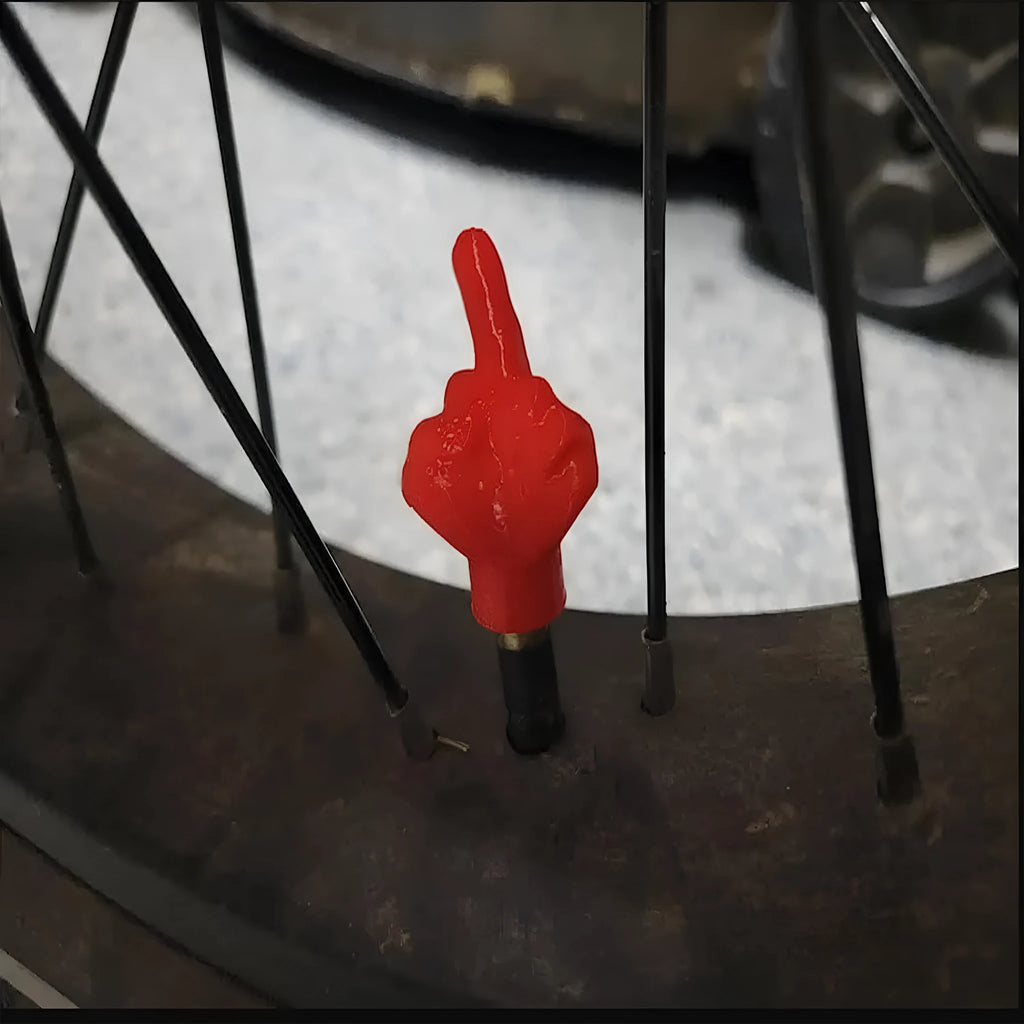 Four latex tyre valve dust caps showing black and skin colour pieces for car wheel valve protection