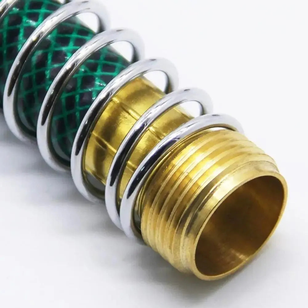 Close-up of a 15cm long brass garden hose spring connector with a visible internal spiral to prevent kinking.