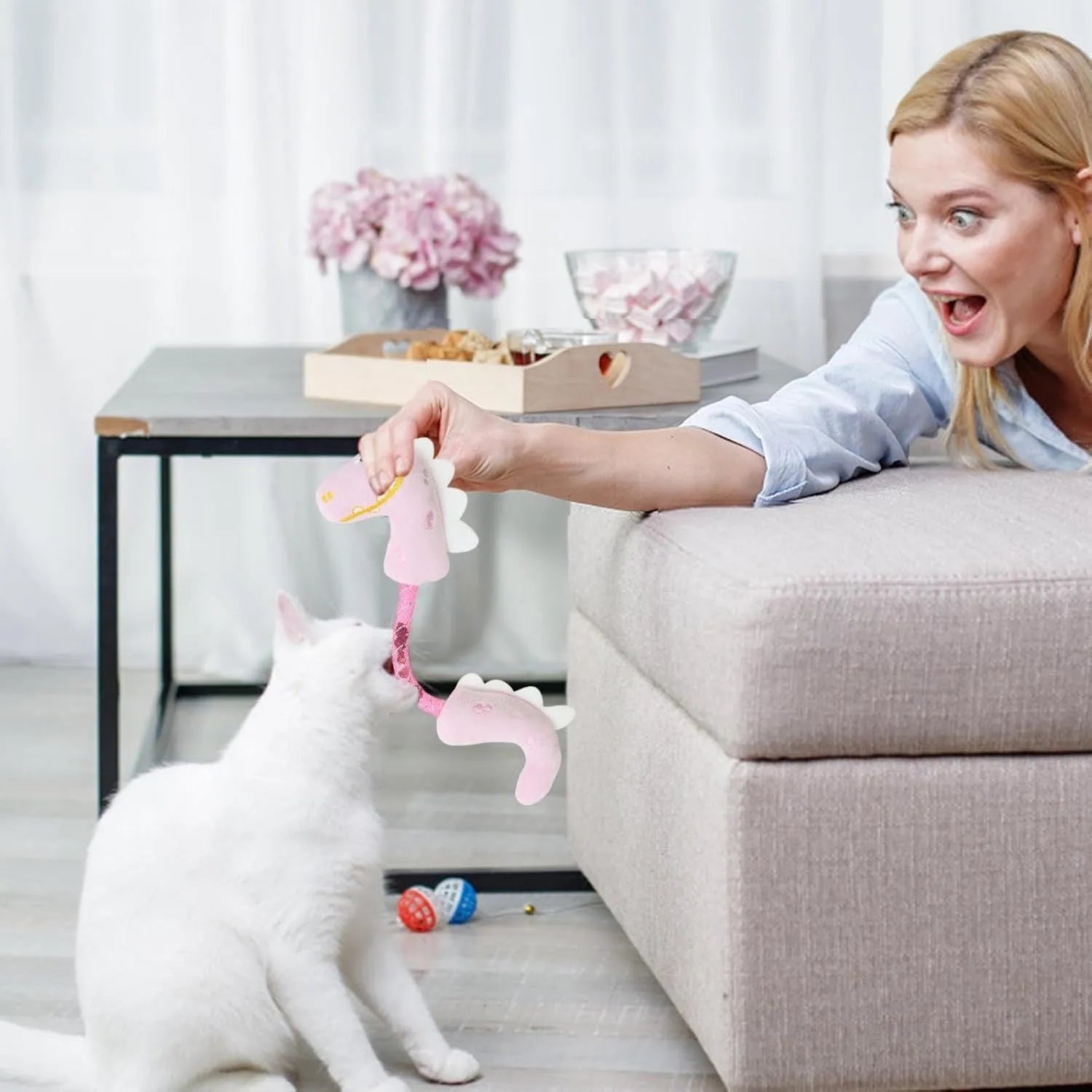 Four interactive cat toys: catnip rope, plush fish, plush mouse, and plush bunny in pink