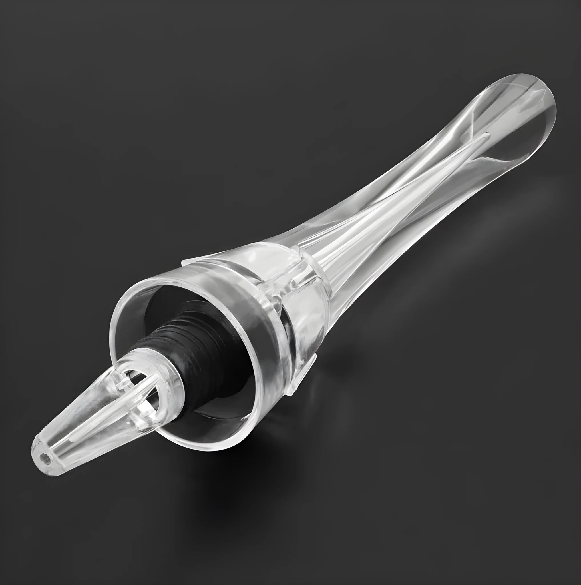 A slender, clear acrylic wine aerator pourer with a stainless steel filter inside, shown next to a wine glass.