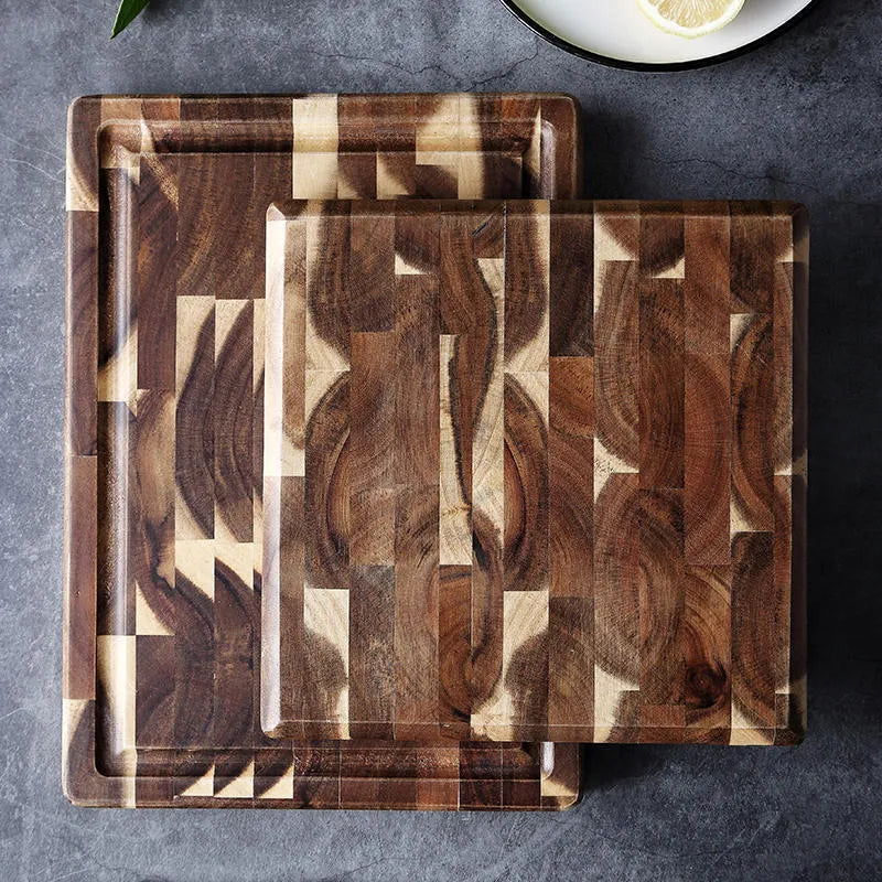 Brown solid acacia wood chopping board with 3cm thickness on a kitchen counter.