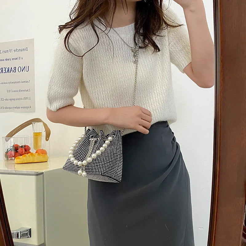 Diamond pattern women's crossbody bag in PU leather with metal chain strap, showing internal phone pocket and change purse.