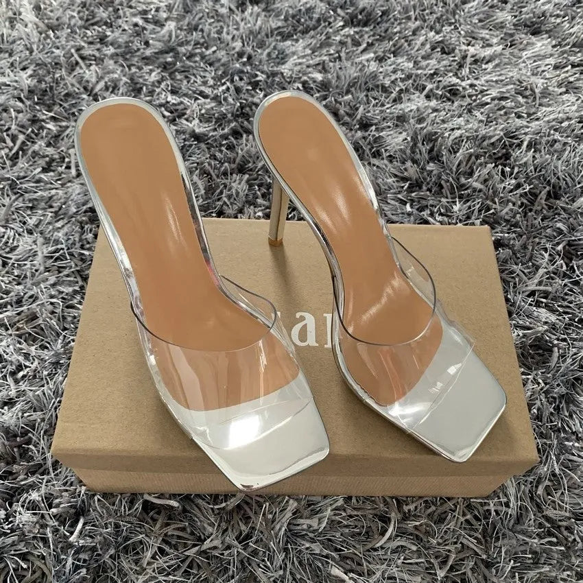 Women's black and silver pointed-toe high heel boots on a white background.