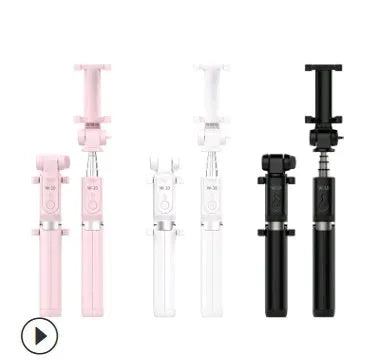 Aluminium Bluetooth selfie stick with tripod base and remote control next to a smartphone.