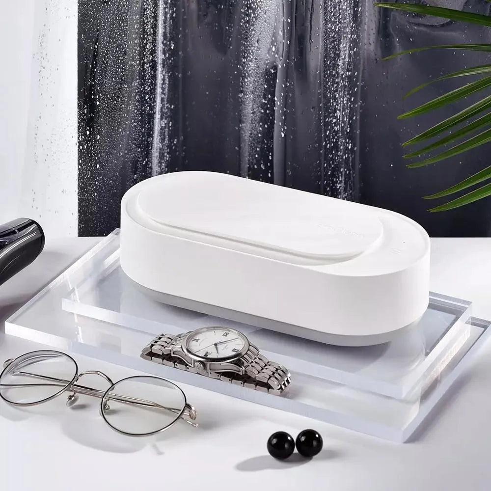 White portable ultrasonic cleaning machine with a stainless steel tank for jewellery and glasses.