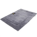 Self-heating pet mat in brown with soft fleece surface and non-slip base on wooden floor