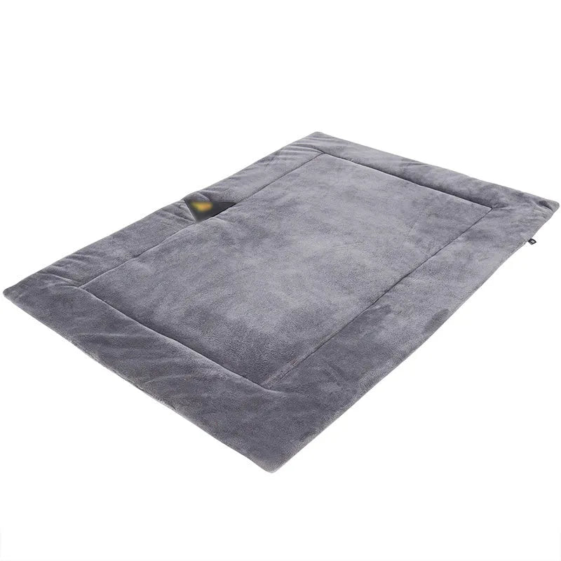 Self-heating pet mat in brown with soft fleece surface and non-slip base on wooden floor