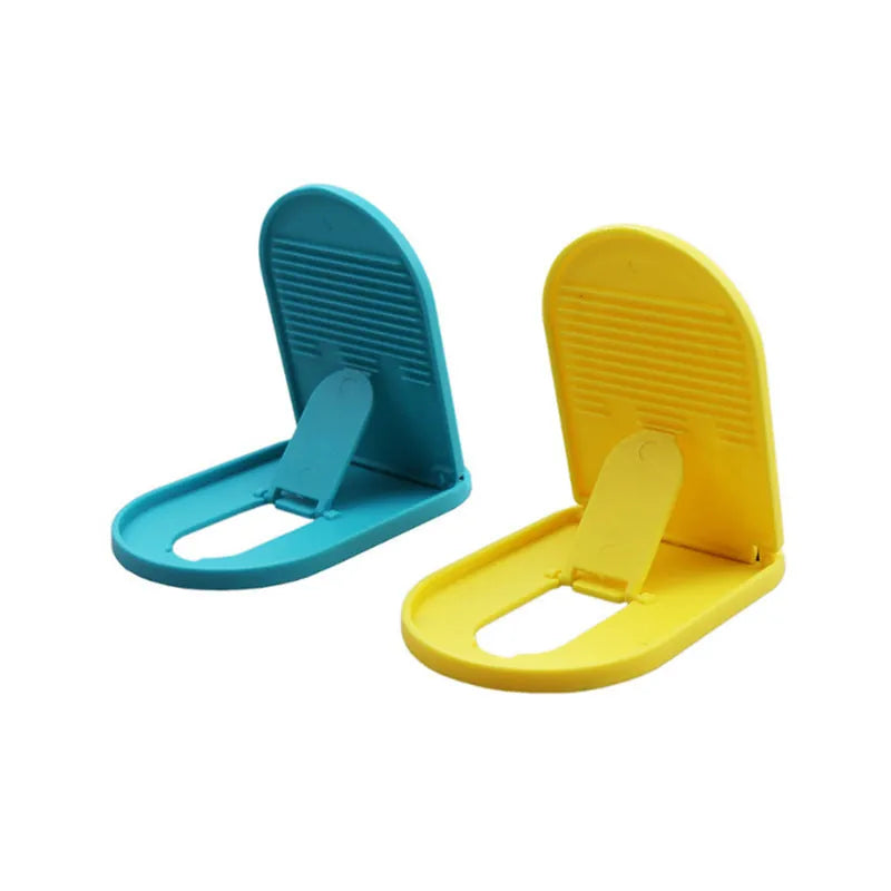 Plastic lazy bracket mobile phone stand shown in one of six available colours: black, blue, grey, pink, white, or yellow.