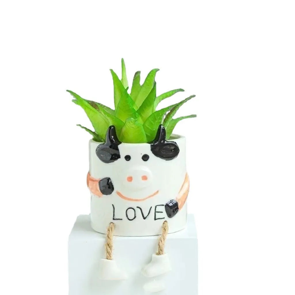 Cartoon style ceramic hanging foot flowerpot for succulent plants on a desktop.